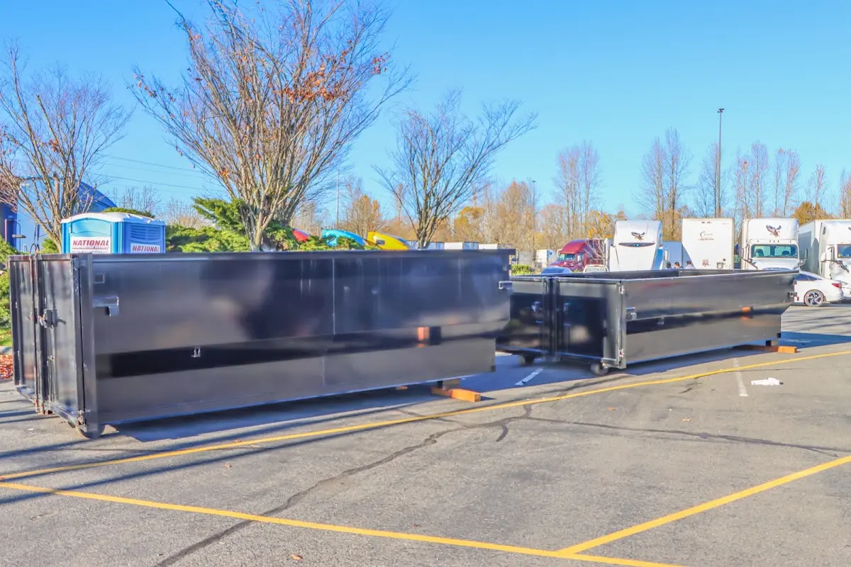 Professional dumpster rental service with roll-off container on residential driveway in Miami Beach